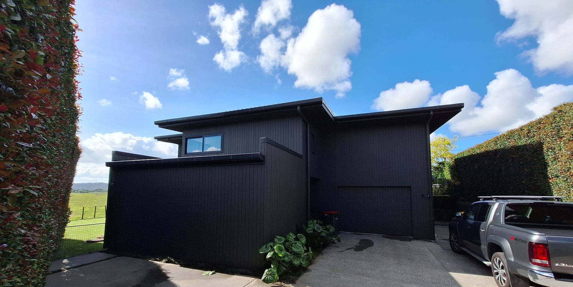 Commercial painting Auckland — modern black-stained cedar building exterior after a full repaint