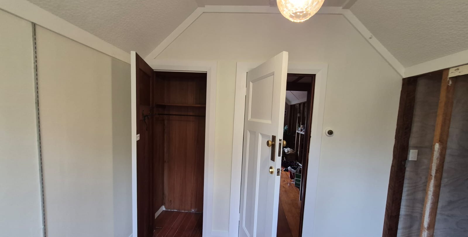 Interior painting Auckland villa — repainted hallway with white doors, trims and ceiling