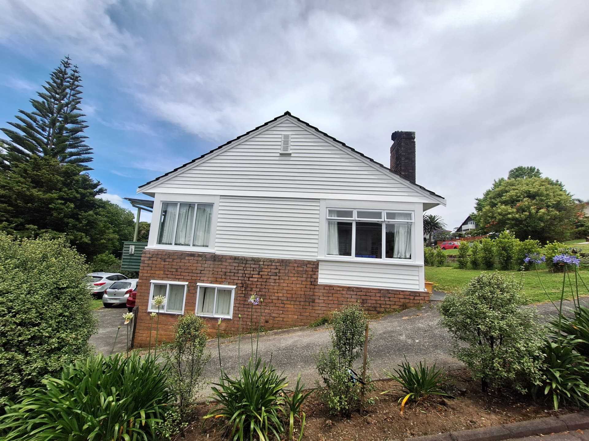 Rental repaint Auckland — white weatherboard bungalow with brick base ready for new tenants